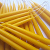 beeswax candles with wicks on a white background