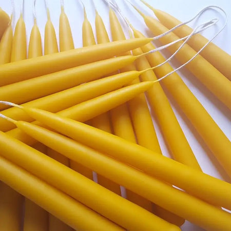 beeswax candles with wicks on a white background