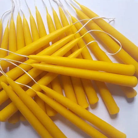 beeswax candles with wicks on a white background
