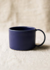Blue mug on a beige surface