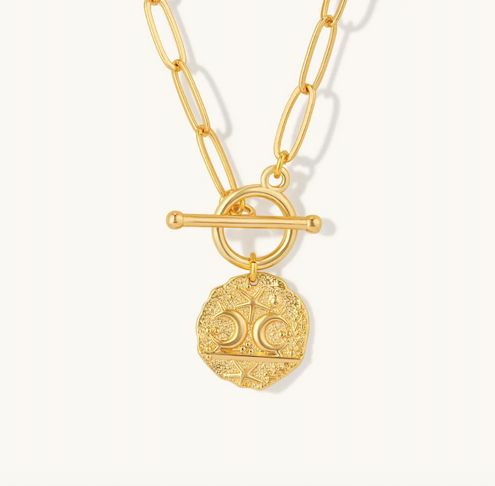 Gold necklace with a detailed pendant on a white background
