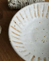 Close-up of a ceramic bowl with textured design on a wooden surface