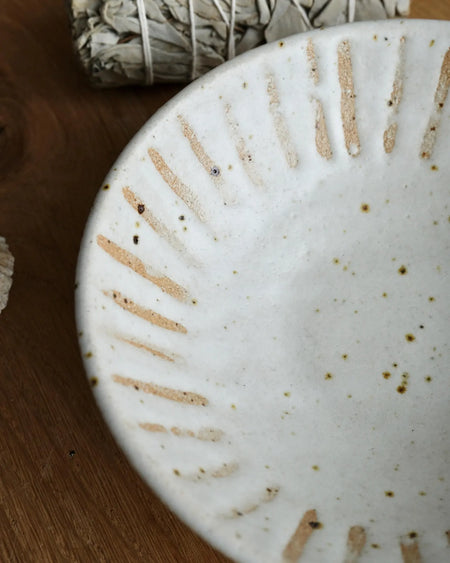 Close-up of a ceramic bowl with textured design on a wooden surface