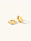 Gold hoop earrings on a white background