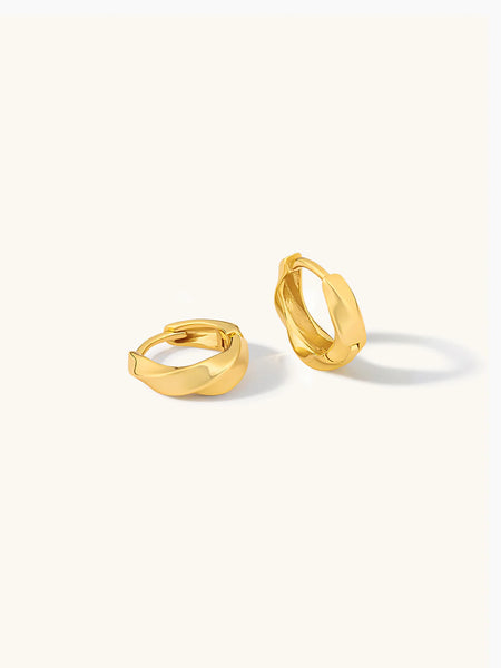 Gold hoop earrings on a white background