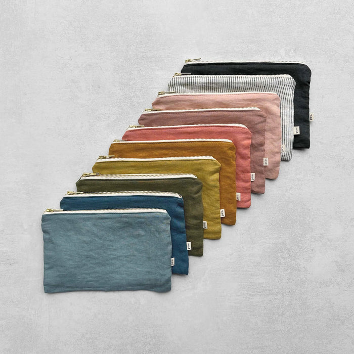 Row of colourful linn pouches on a light grey background