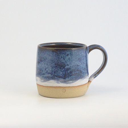 Ceramic mug with blue and beige design on a white background