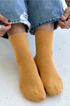 person wearing yellow socks and blue jeans 