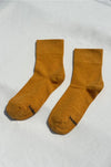 pair of yellow socks on a white surface