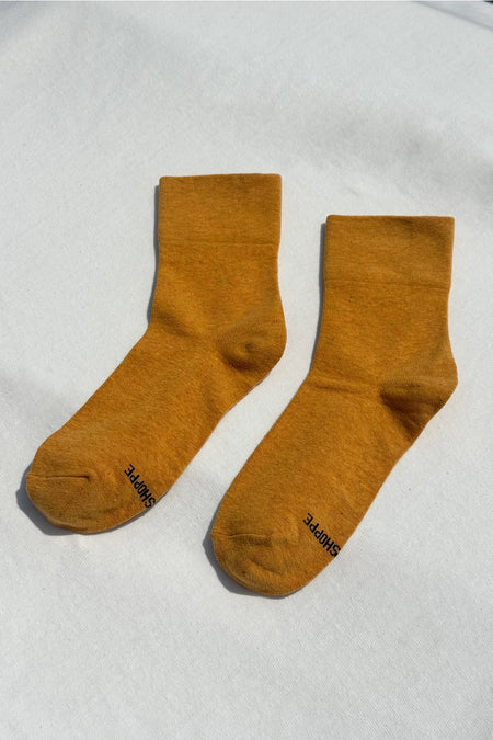 pair of yellow socks on a white surface