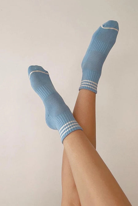 Person wearing blue socks with white stripes 