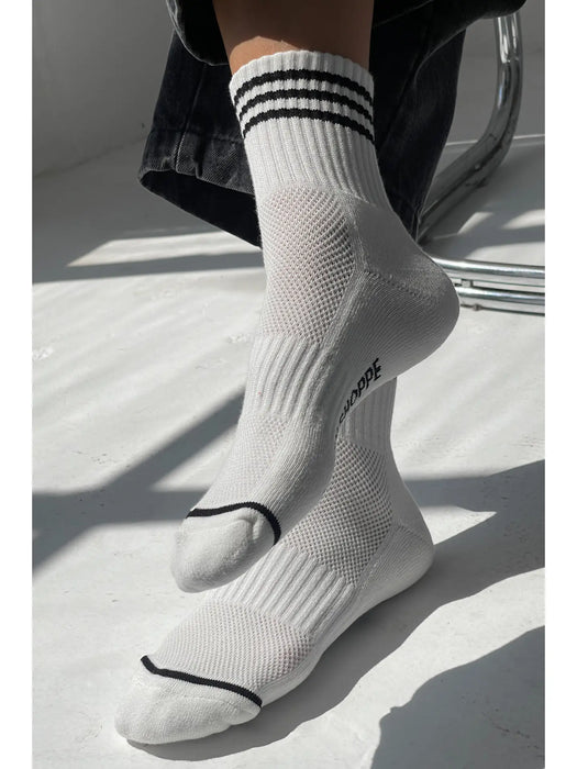 White socks with navy stripes on a light grey background
