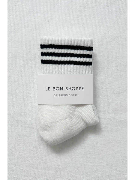 White sock with navy stripes and 'Le Bon Shoppe' label on a white background