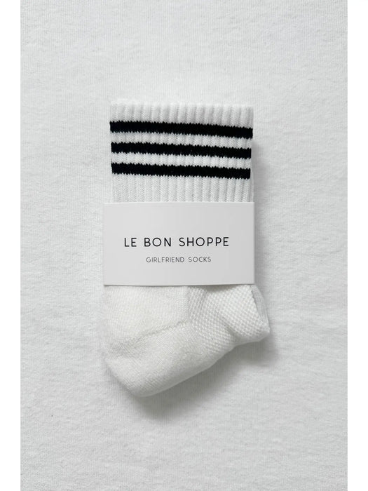 White sock with navy stripes and 'Le Bon Shoppe' label on a white background