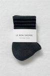 Pair of dark grey socks with a white label on a white background
