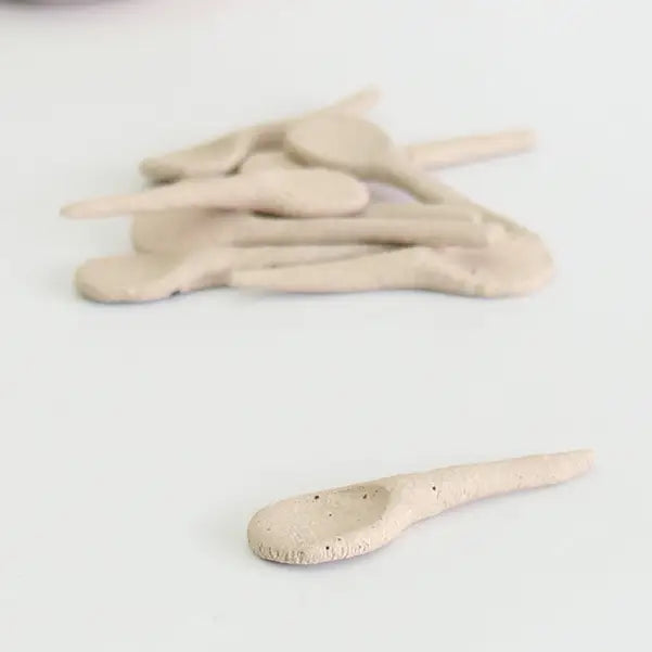 Set of ceramic spoons on a white background
