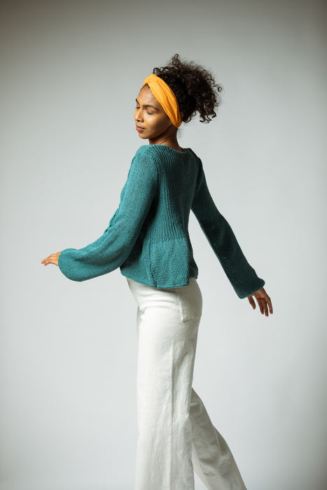 The hand knitted organic cotton cardigan in Turquoise